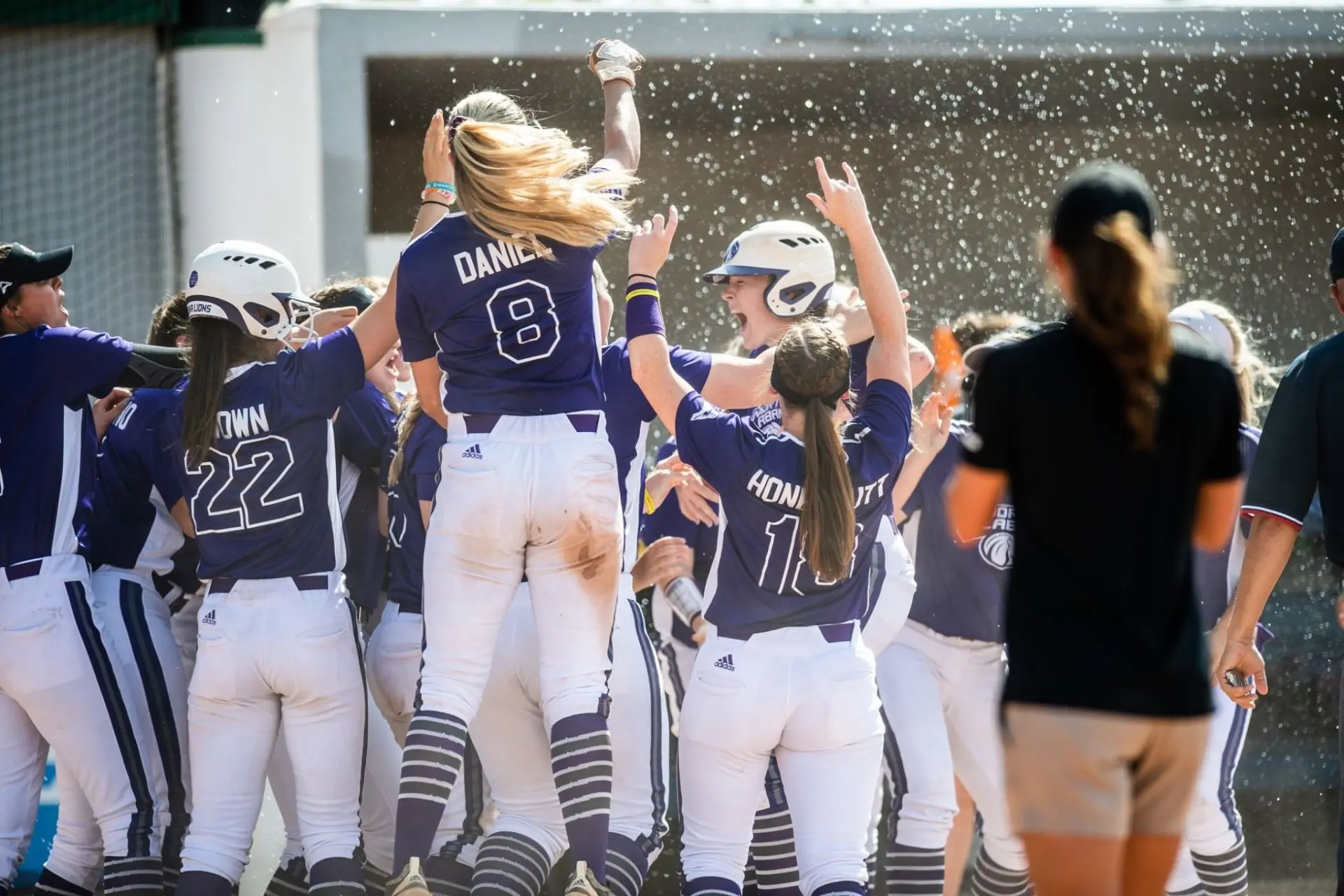 North Alabama players jumping and celebrating at home plate